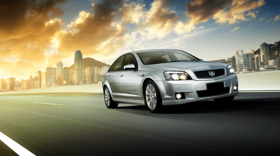 A sleek Holden Commodore cruising on the road, showcasing its new design and powerful performance.